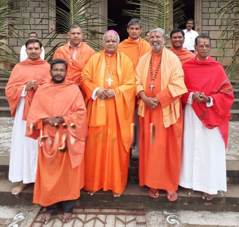 Christian priests in saffron cloth and rudraksha malas.