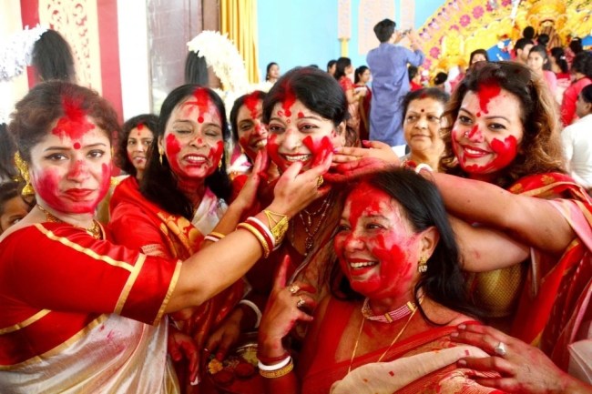 Women apply vermilion on each other's face during 'Sindoor Khel' on Vijayadashmi in Lucknow. Women apply vermilion on each other's face during 'Sindoor Khel' on Vijayadashmi the tenth day of Durga Puja in Lucknow.